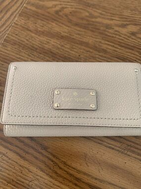 kate spade Cream Pebbled Leather Fold-Over Wallet with Gold Plaque